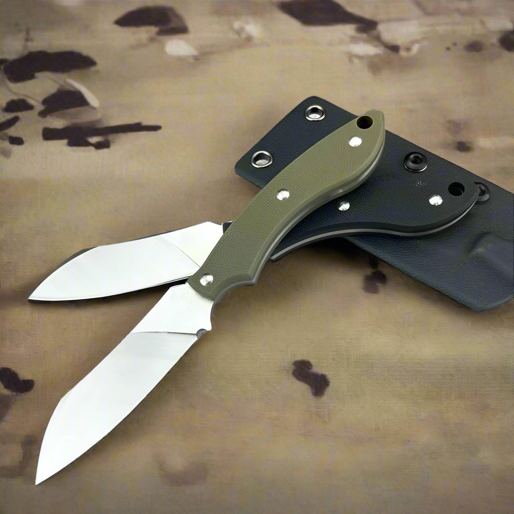 Folding knife with green handle and black sheath on a concrete surface.